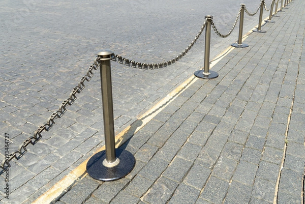Fototapeta Border of old and modern stone tiles on Red Square in Moscow. Fence posts on pedestrian paths. Sidewalk