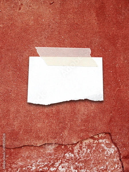 Obraz Close-up of one blank ripped piece of paper sheet frame with adhesive tape on red scratched and cracked plastered wall background