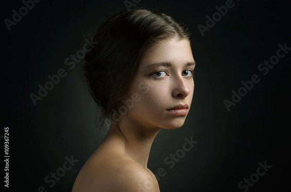 Obraz Dramatic portrait of a girl theme: portrait of a beautiful girl on a background in the studio