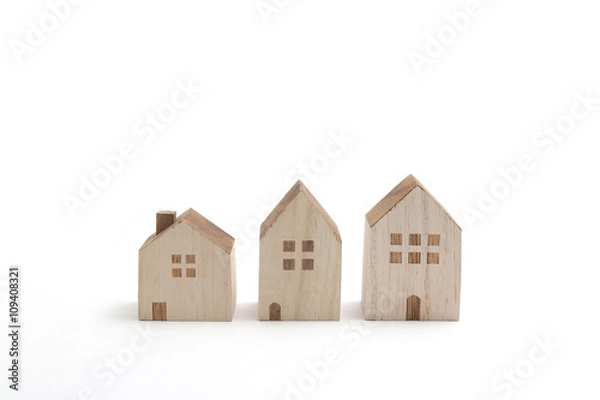Fototapeta Miniature houses on white background. Building blocks arranged in row.