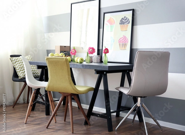 Fototapeta Modern room interior with table, chairs and pictures on the wall