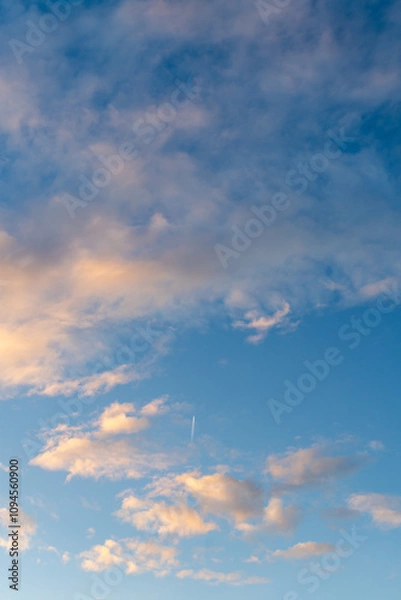 Obraz Bright blue sky with golden fluffy clouds
