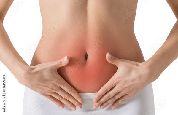 Fototapeta Woman holding hands on a belly. Stomach-ache concept. Isolated on white.