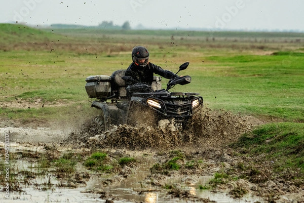 Obraz ATV rider splashing through muddy terrain adventure
