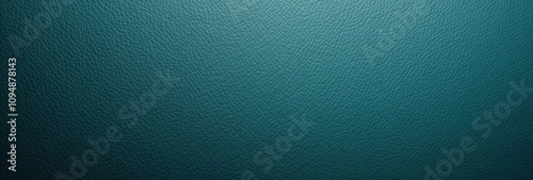 Fototapeta An empty, smooth teal-colored leather surface illuminated by a spotlight.