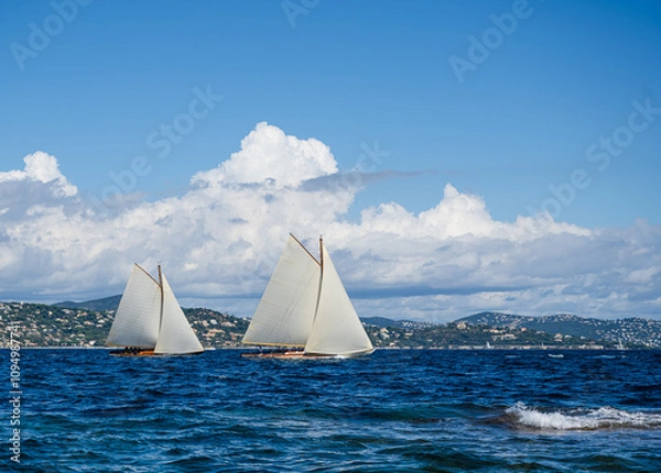 Fototapeta Historic sail yachts in the bay of St. Tropez sailing in blue water under a blue sky on a sunny day.
