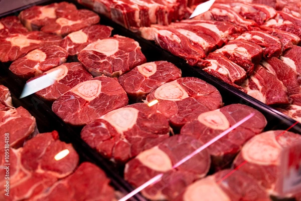 Fototapeta Raw beef meat osso buco shank steak lower part of cows foreleg. Red meat selection in butchers shop, fresh beef osso.