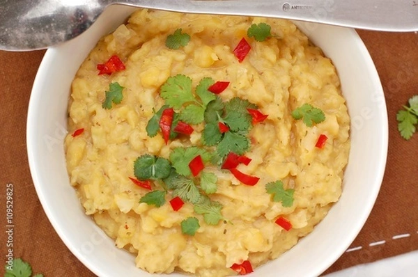 Fototapeta Pease pudding with coriander and chilli in the bowl