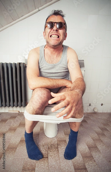 Obraz Man sitting on a toilet bowl