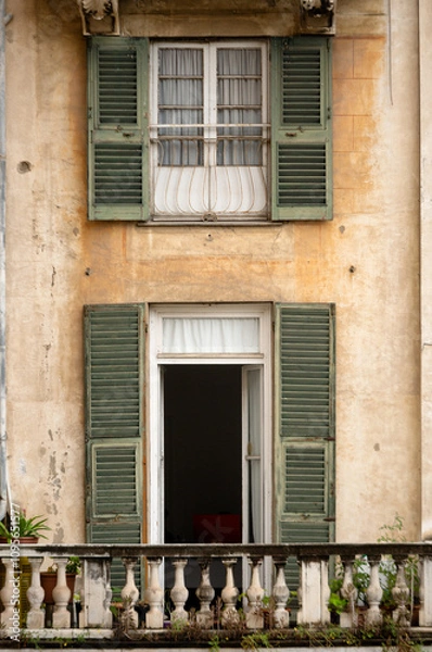 Fototapeta Building with timber shutters and small balcony
