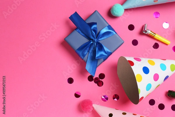 Fototapeta Shiny confetti and party decor on pink background, flat lay. Space for text