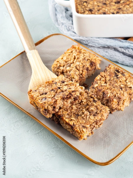 Fototapeta Baked oatmeal peanut butter banana cake bars with chocolate chips