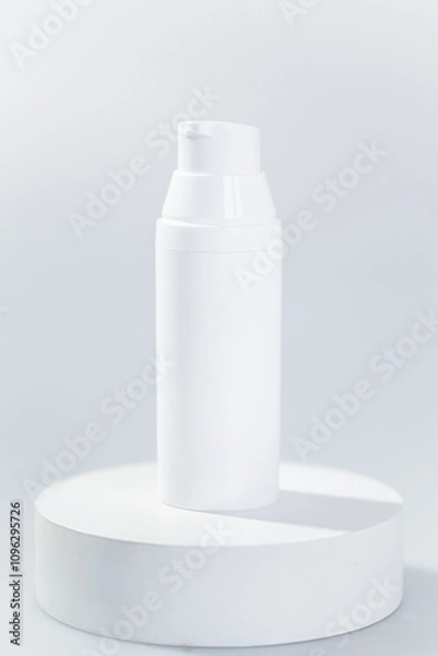 Fototapeta White pump bottle mock up on a circular white pedestal