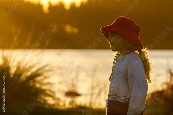 Obraz child by the lake at sunset