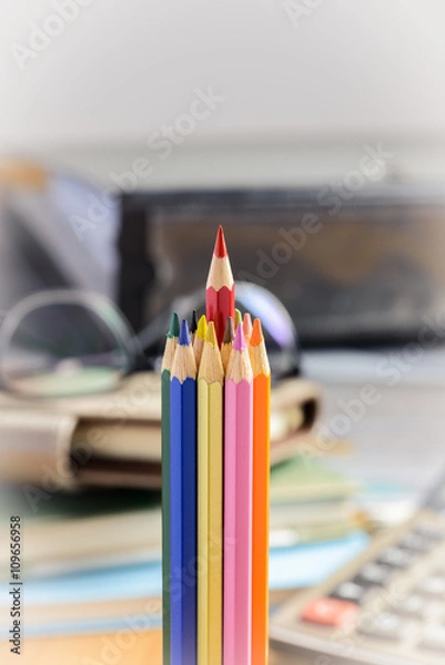 Obraz Red pencil standing out from a bunch of colored pencils
