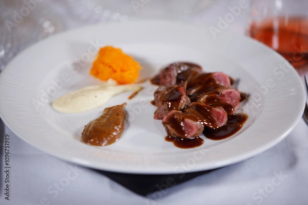 Fototapeta Ready to be eat, plate of cooked meat with sauces in side