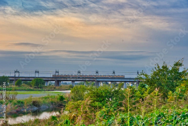 Fototapeta 夕焼けの中を走る電車