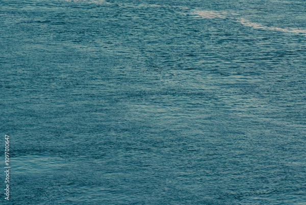 Fototapeta Imagine a stunning ocean view with gentle waves lapping the shore and beautiful sky reflections, creating a tranquil atmosphere for nature lovers and those seeking peace and relaxation