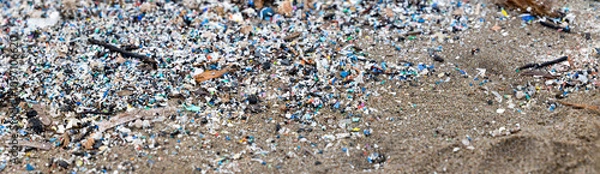 Fototapeta microplastics on the beach, an example of pollution, panorama banner