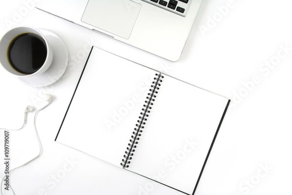 Obraz Creative flat lay photo of workspace desk with laptop, earphone, coffee and blank notebook with copy space background, minimal style