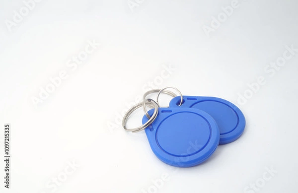Fototapeta 2 blue RFID (Radio Frequency Identification) keychain receivers on white background. Used by electronics, mechatronics, and networking engineers.