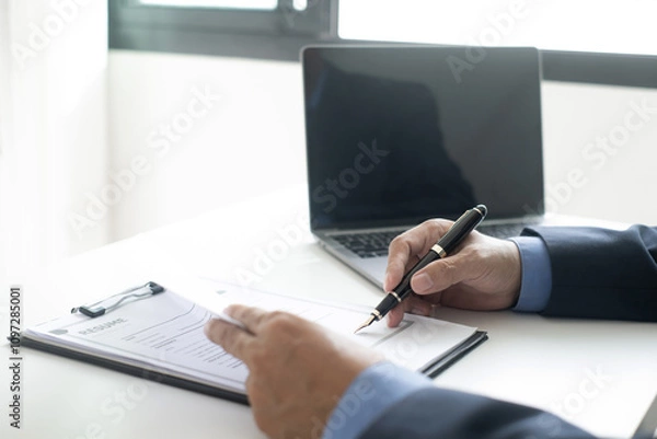 Fototapeta Executive CEO businessman checking job applicant documents resumes, interviews, and signing to approve the contract in the office room