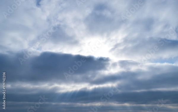 Fototapeta Sunlight filtering through the clouds