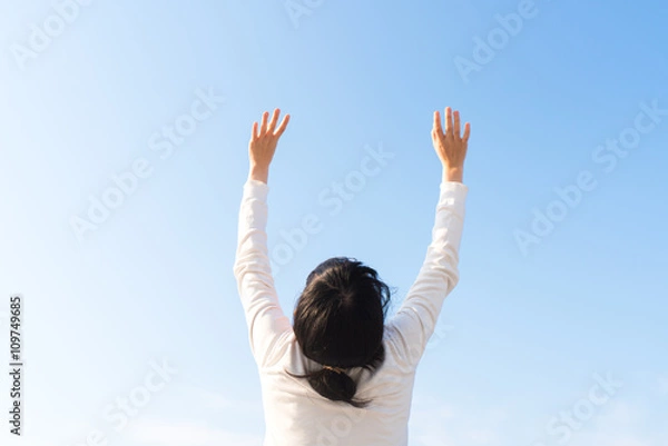 Fototapeta 手を空にかざす女性