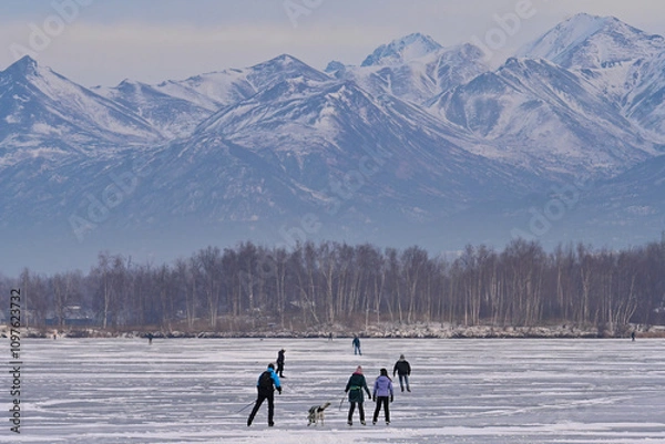 Fototapeta Alaskan families hit the ice on Wasilla Lake for a day of skating and fun.