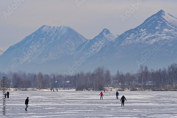 Fototapeta Alaskan families hit the ice on Wasilla Lake for a day of skating and fun.