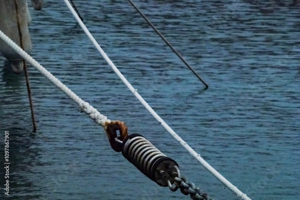 Obraz Sea mooring ropes in the marina against the water.