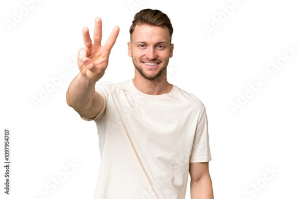 Fototapeta Young blonde caucasian man over isolated background happy and counting three with fingers