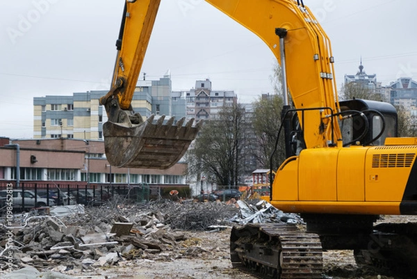 Fototapeta A construction site featuring an excavator set within an urban environment or area