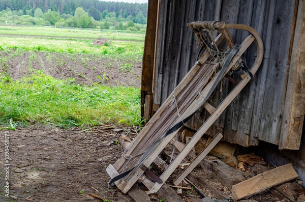 Fototapeta there is a wooden sleigh with a stretched rope. Wooden large sleigh for transportation.
