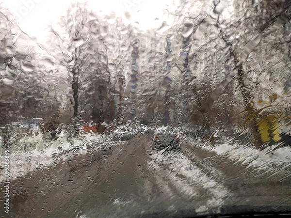 Fototapeta the view through the rain-soaked car window