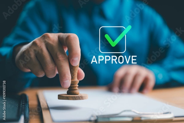 Fototapeta Sign Approved Stamp On Document to permit and certify for work document and visa At Desk, signing a business contract approval of contract documents confirmation or warranty certificate.