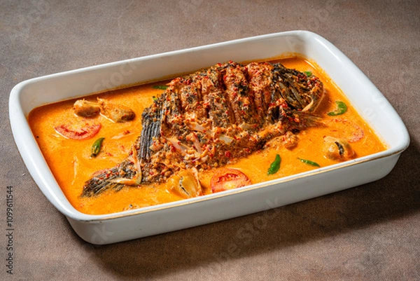 Fototapeta Fried Gourami cooked in spicy sour curry with asam cikala