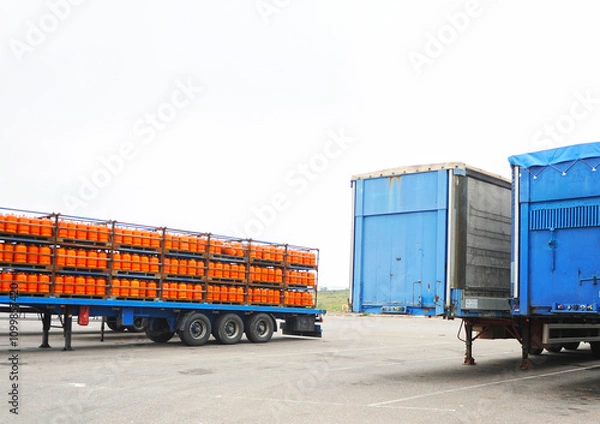Obraz Repsol butane cylinders. Truck trailer loaded with butane gas cylinders for domestic use. Energy supply for the home