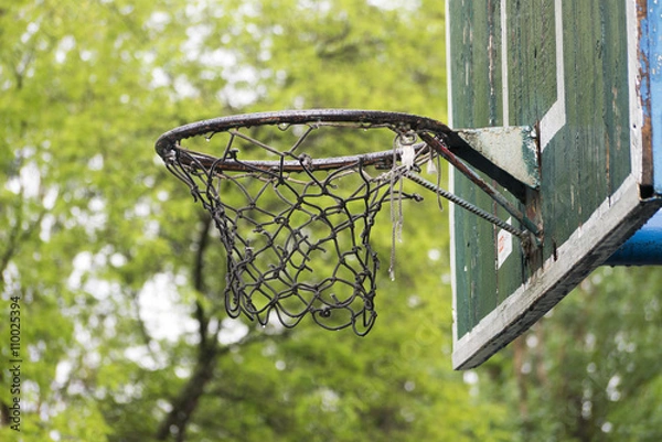Obraz Old basketball hoop in the city park in rainy day.