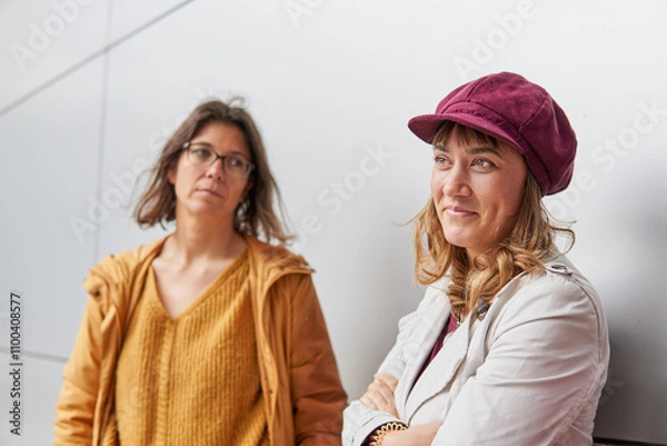 Fototapeta Sucessful businesswoman with empowered expression while her colleague is looking at her with envy