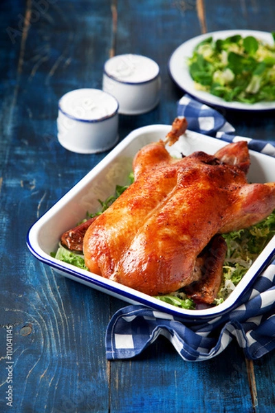 Obraz Roast duck in enamel baking dish, selective focus