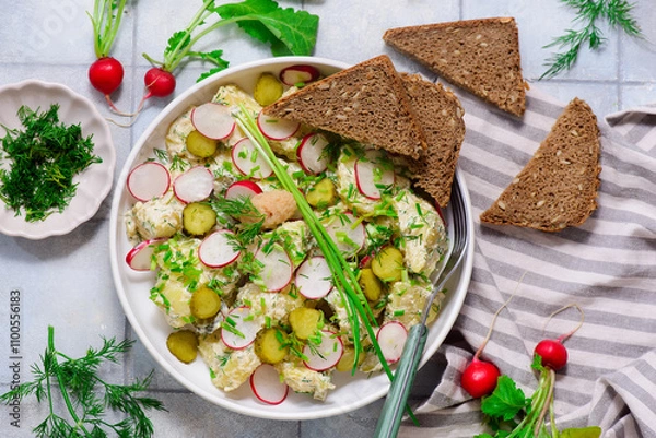 Fototapeta Scandinavian potato salad with gherkins and pollock caviar.
