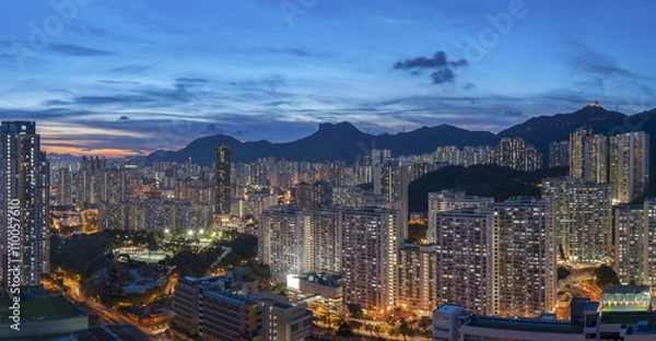 Fototapeta Panorama of Hong Kong City skyline and Lion Rock Hill at dusk