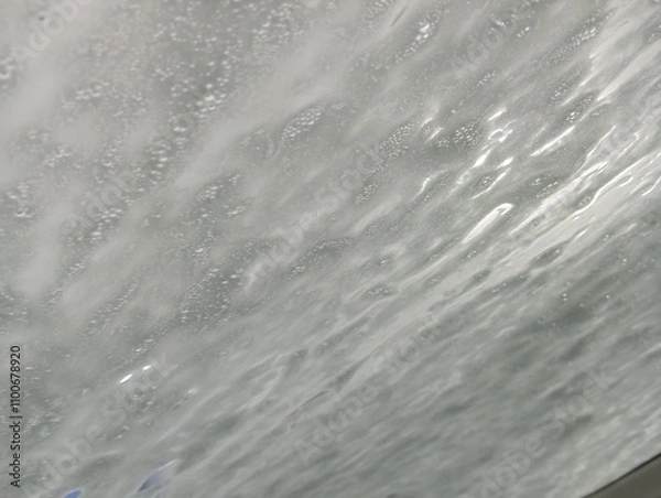Fototapeta water flowing into the water. At the car wash. Foam on the car window during washing. A clean car