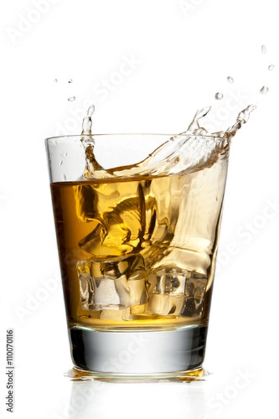 Fototapeta glass of apple juice with ice cubes.