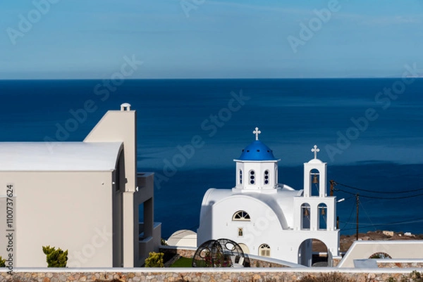 Obraz Orthodox church of Santorini with the dome painted an intense blue which makes it fascinating and typical of the island.