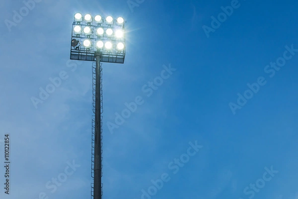 Fototapeta Spotlights in stadium blue sky evening