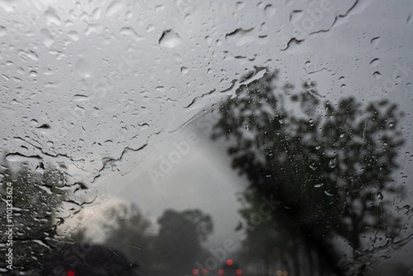 Obraz Raindrops on the car glass while driving through heavy rain and storm.