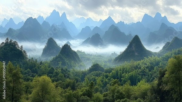 Obraz Serene mountain landscape shrouded in mist, showcasing lush greenery and towering peaks.