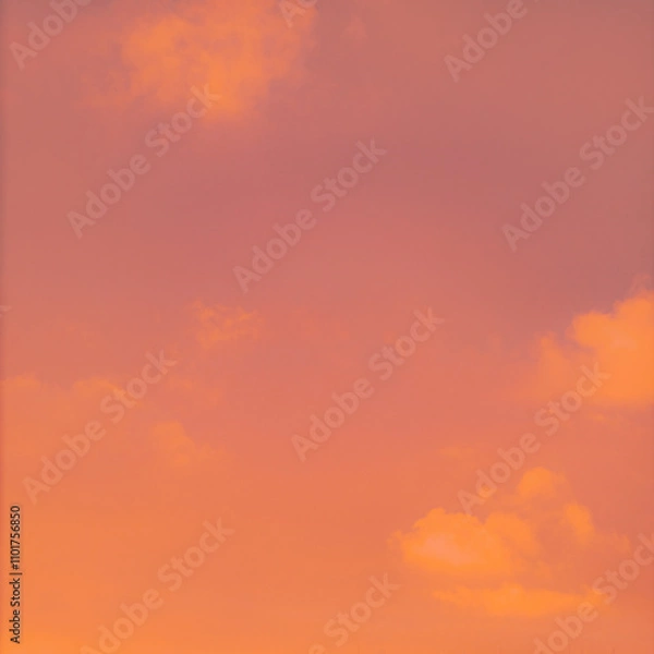 Fototapeta A bright and beautiful orange sky, with clouds at dawn, creates a heavenly backdrop for the sunrise.